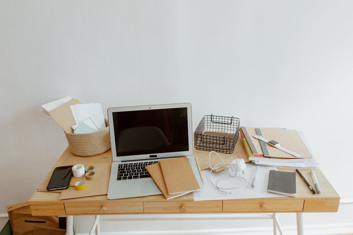 Tidy organized desk illustrating clear energy flow in a feng shui office layout Clean, organized desk with a laptop and notebooks, illustrating feng shui energy flow in an office