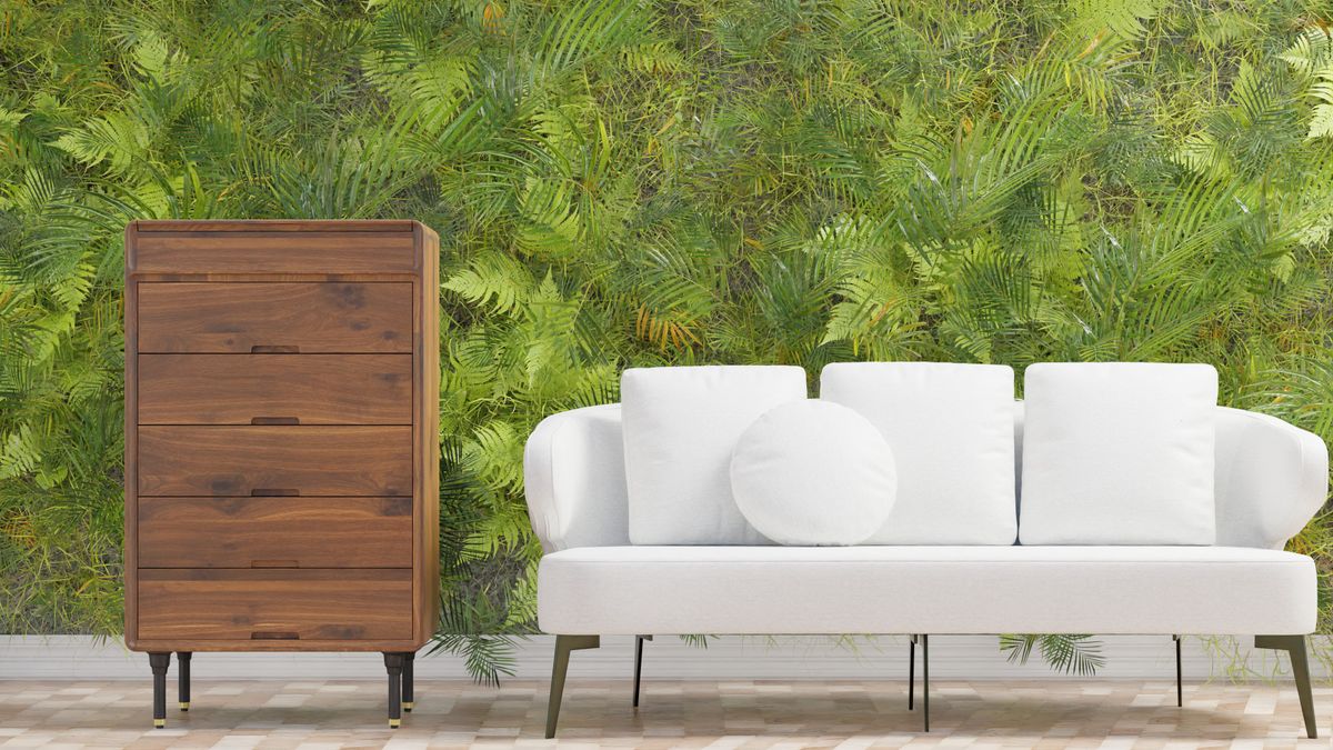 Modern living room with a lush green plant wall and a white sofa, illustrating a greenery accent wall