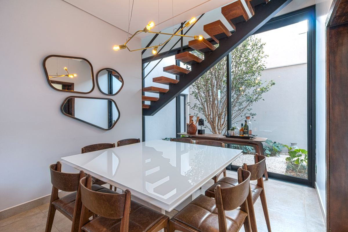 Decorative mirror on a dining room wall illustrating correct placement of mirrors for a dining area Dining area with a decorative wall mirror beside the table showing where to place mirrors for a dining room wall