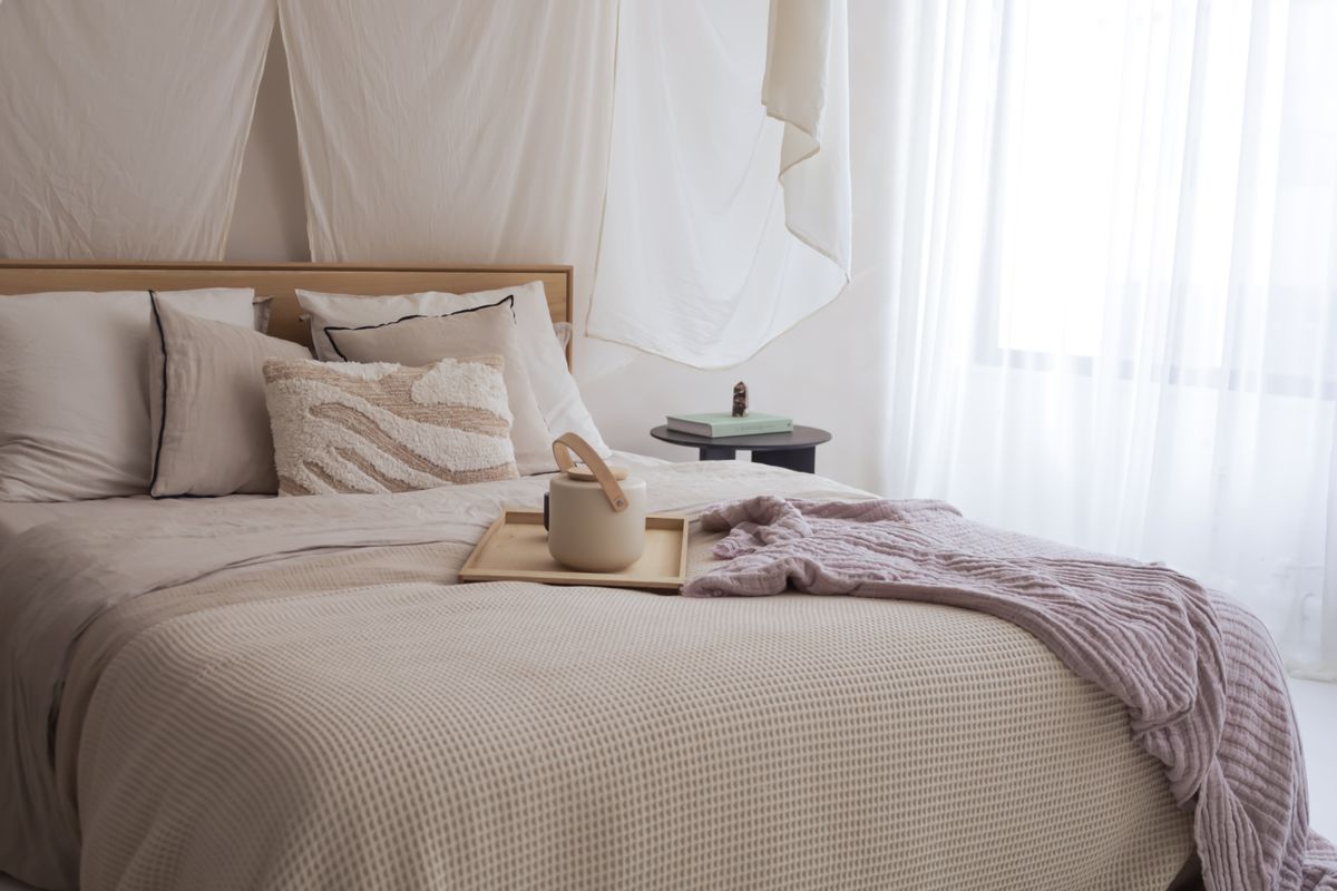 Serene bedroom with neutral textiles, soft lighting, and a cozy restful atmosphere illustrating feng shui bedroom principles