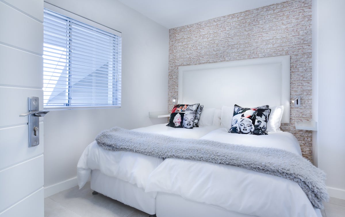 Serene bedroom illustrating feng shui bed direction as a separate question from placement Serene bedroom with neutral bedding, illustrating that feng shui bed direction is a separate question from bed placement