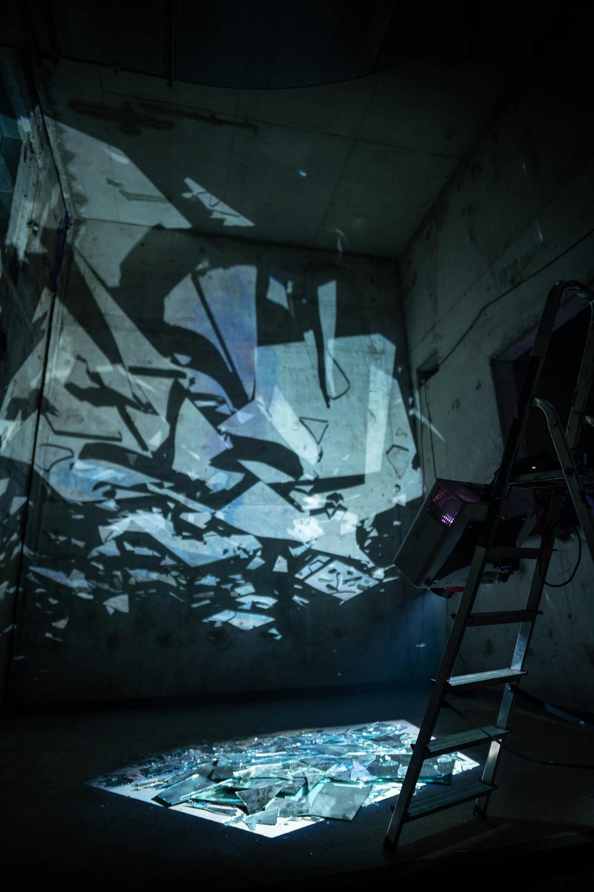 Abstract broken glass reflections symbolising fragmented self-image in broken mirror dreams Abstract broken glass with light reflections in a dark room evoking shattered self-image in broken mirror dreams