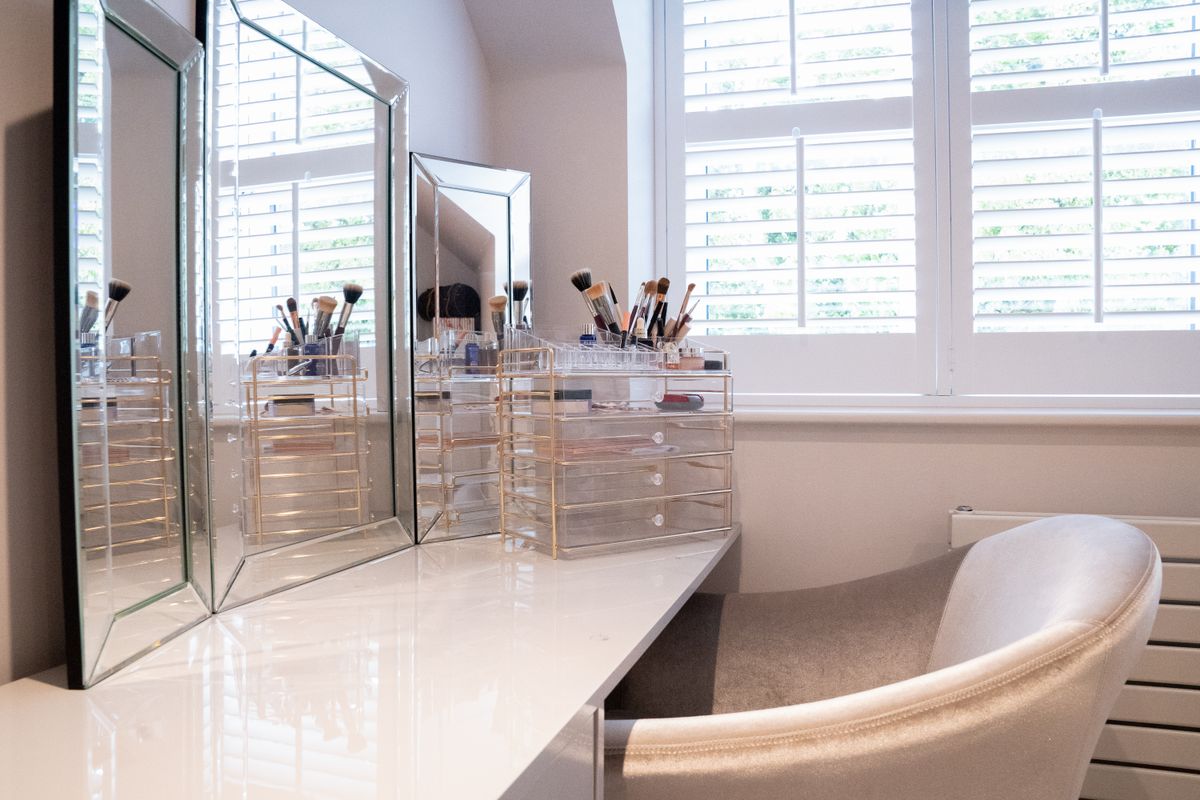 Vanity with mirrors illustrating vanity mirror shapes and styles Bathroom with dual oval mirrors and stylish fixtures, illustrating vanity mirror shapes and styles