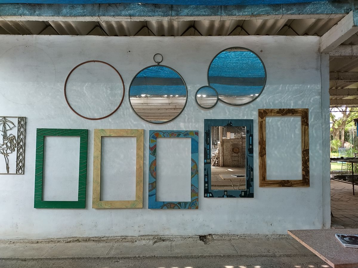 Framed and round mirrors arranged on a wall illustrating a framed-mirror grid accent wall Wall arrangement of framed and round mirrors, illustrating a framed-mirror grid accent wall