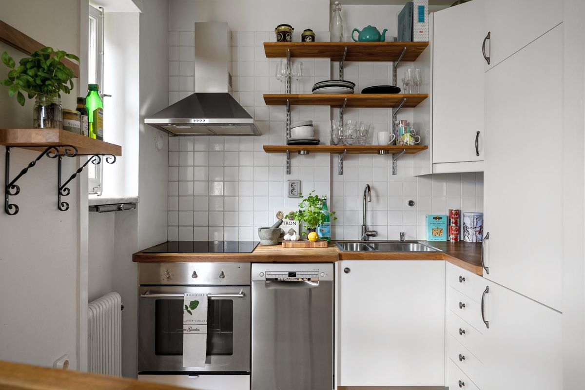 Vertical open shelving illustrating feng shui decluttering and storage in a small apartment Small space with open vertical shelving for storage, illustrating feng shui decluttering in a studio apartment