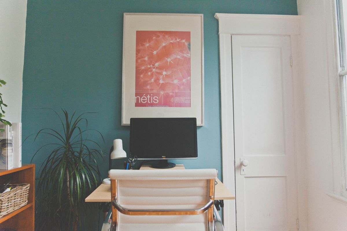 Home office desk in the command position illustrating the key feng shui office layout rule Minimalist home office with a desk and chair positioned to view the room, illustrating the feng shui command position