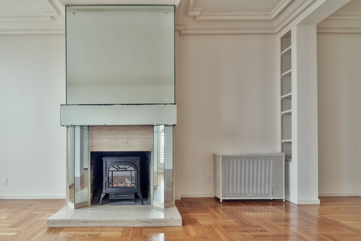 Mirror over a fireplace mantel illustrating a classic living room mirror idea Modern living room with a mirrored fireplace as a focal point, illustrating a mirror over the mantel