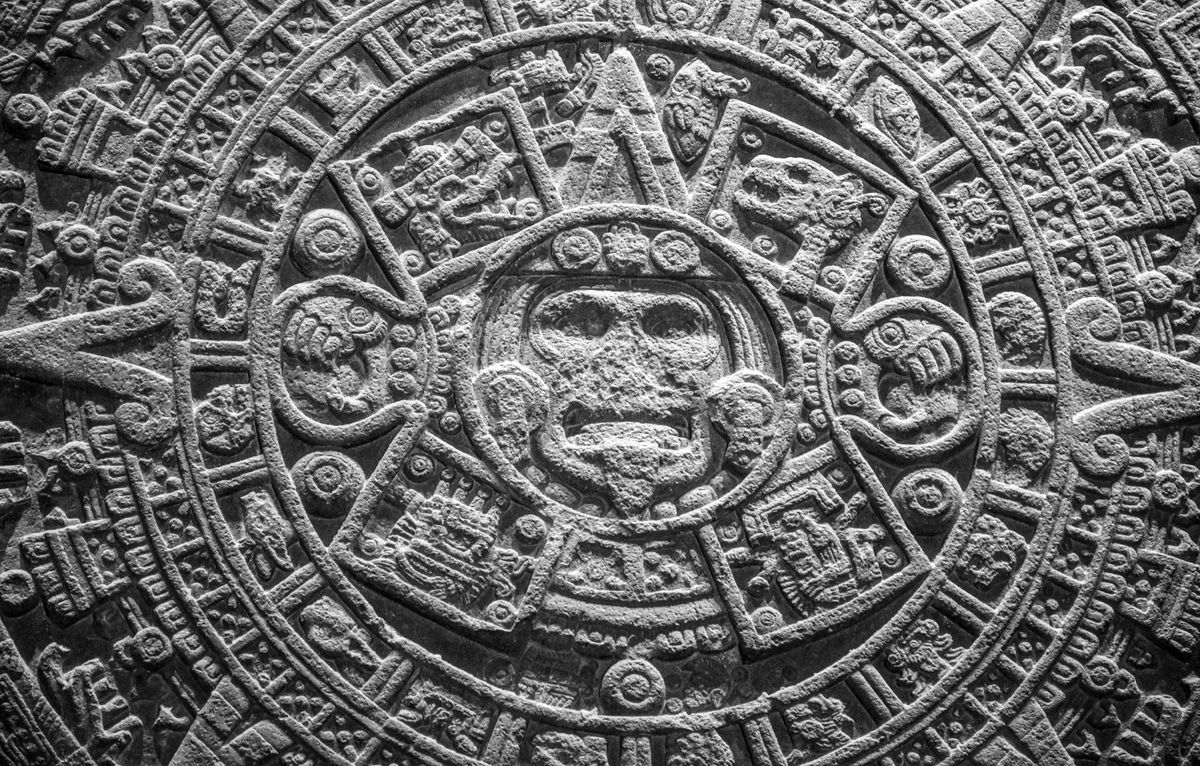 Close-up of the Aztec calendar stone showing ancient Mesoamerican craftsmanship linked to the obsidian black mirror scrying tradition