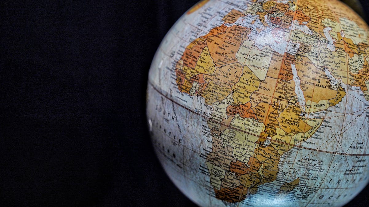 Close-up of a vintage globe highlighting Africa and the Middle East with intricate geography, representing the global diversity of mirror superstitions and cultural beliefs worldwide