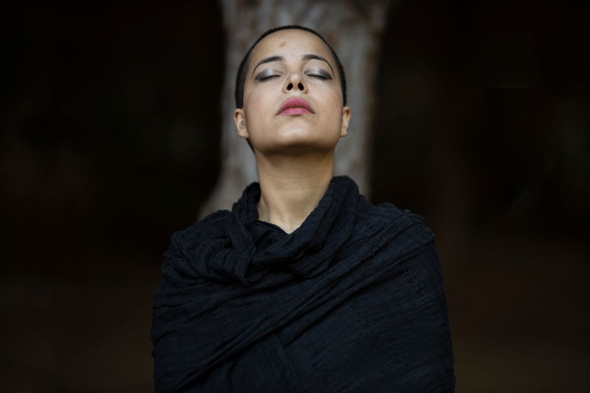 Serene portrait of a woman with eyes closed in deep stillness representing the receptive state behind black mirror scrying