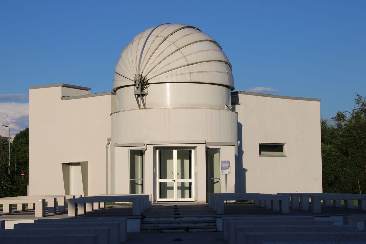 White domed astronomical observatory surrounded by greenery showing how mirror precision spans from everyday household use to the scientific frontier of gravitational wave detection and space telescope optics