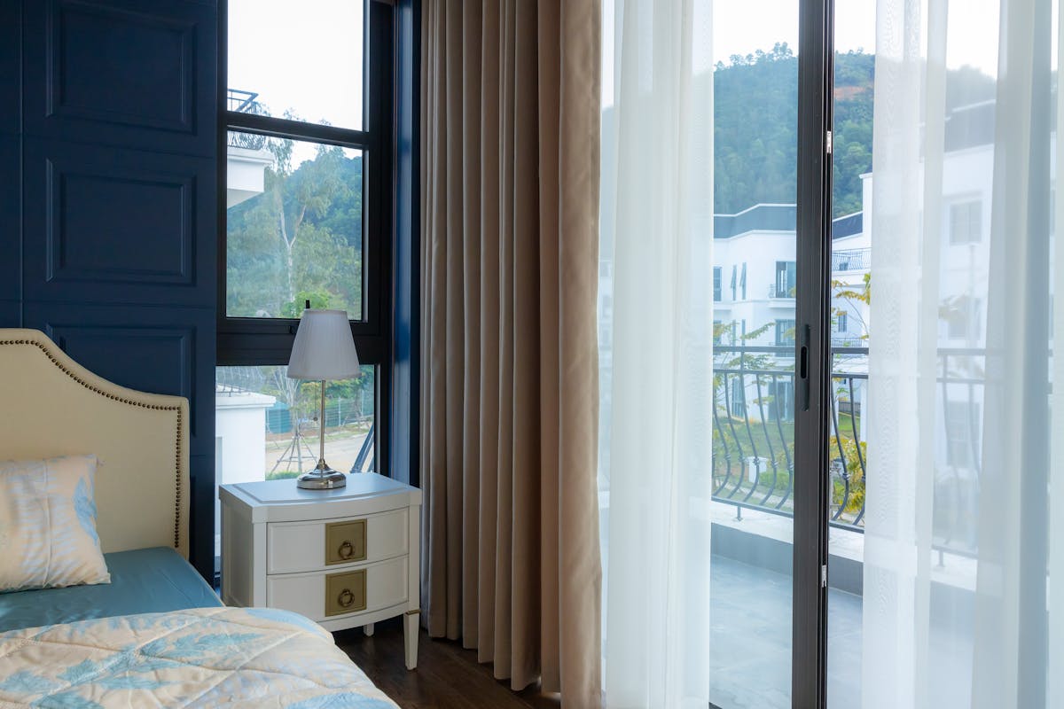 Modern bedroom with large windows and an open view, illustrating why feng shui treats a window as empty support