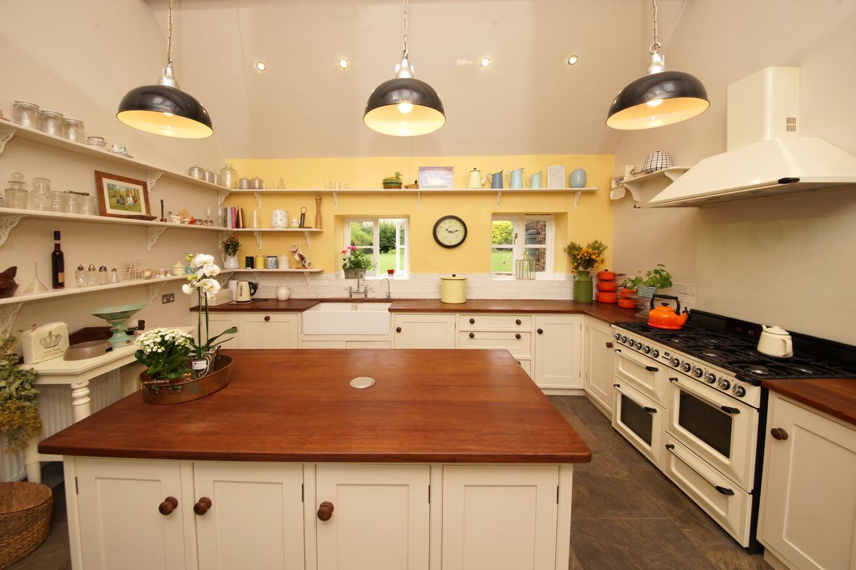 Charming farmhouse kitchen with open shelving and vintage decor, illustrating matching metal wall art to kitchen style