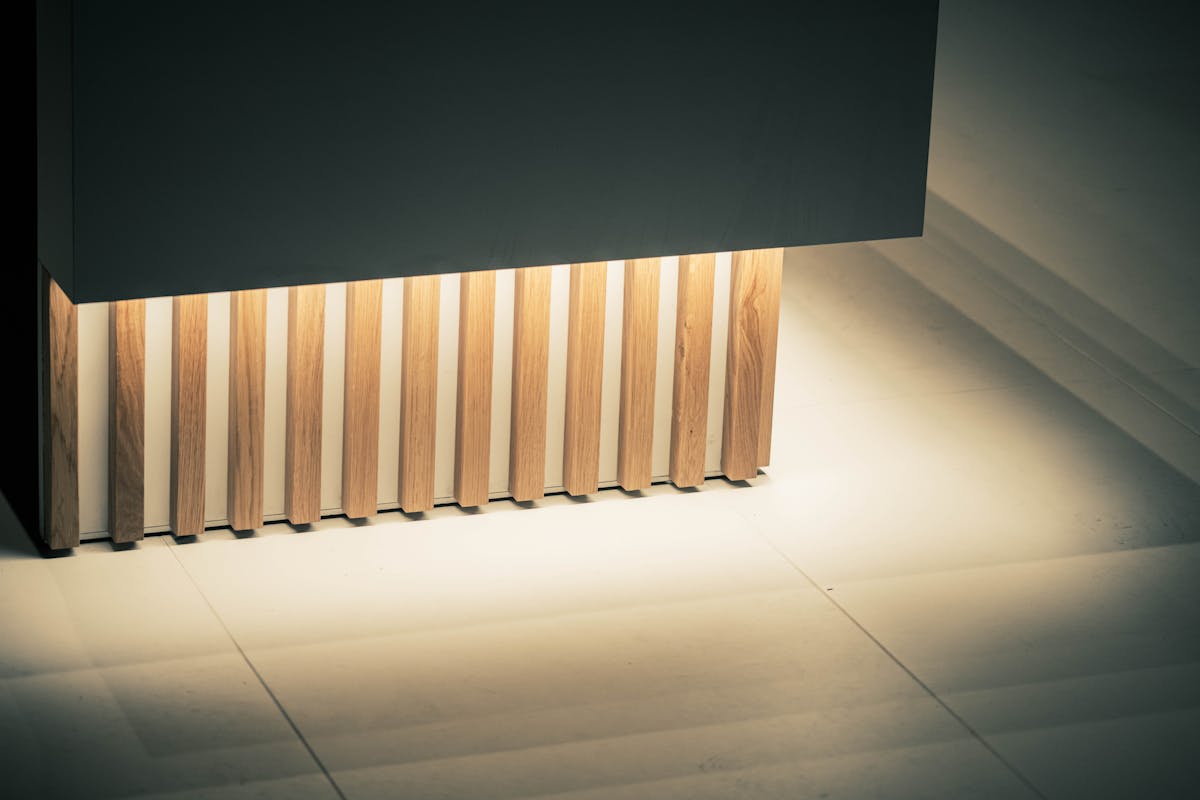 Contemporary interior with illuminated vertical wood slat paneling, illustrating wood slat wall decorations