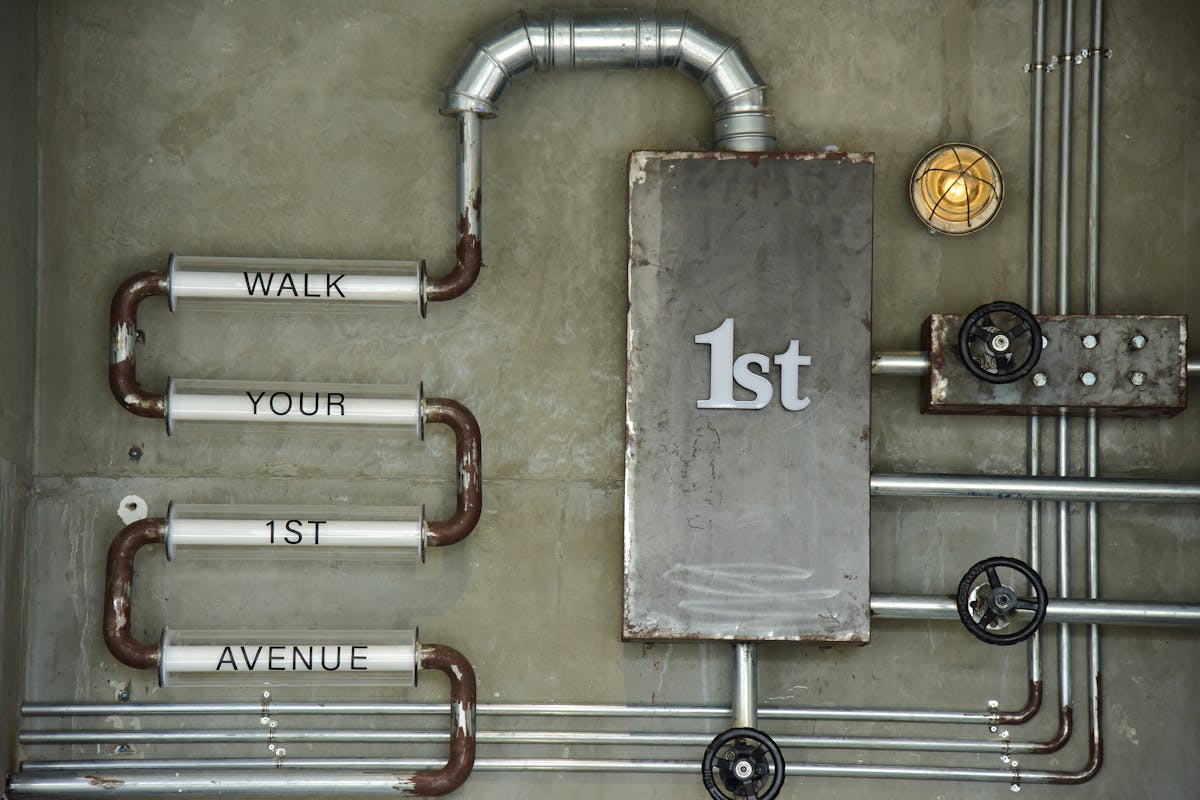 Industrial-style metal wall art on a concrete wall, illustrating metal wall art finishes for a kitchen