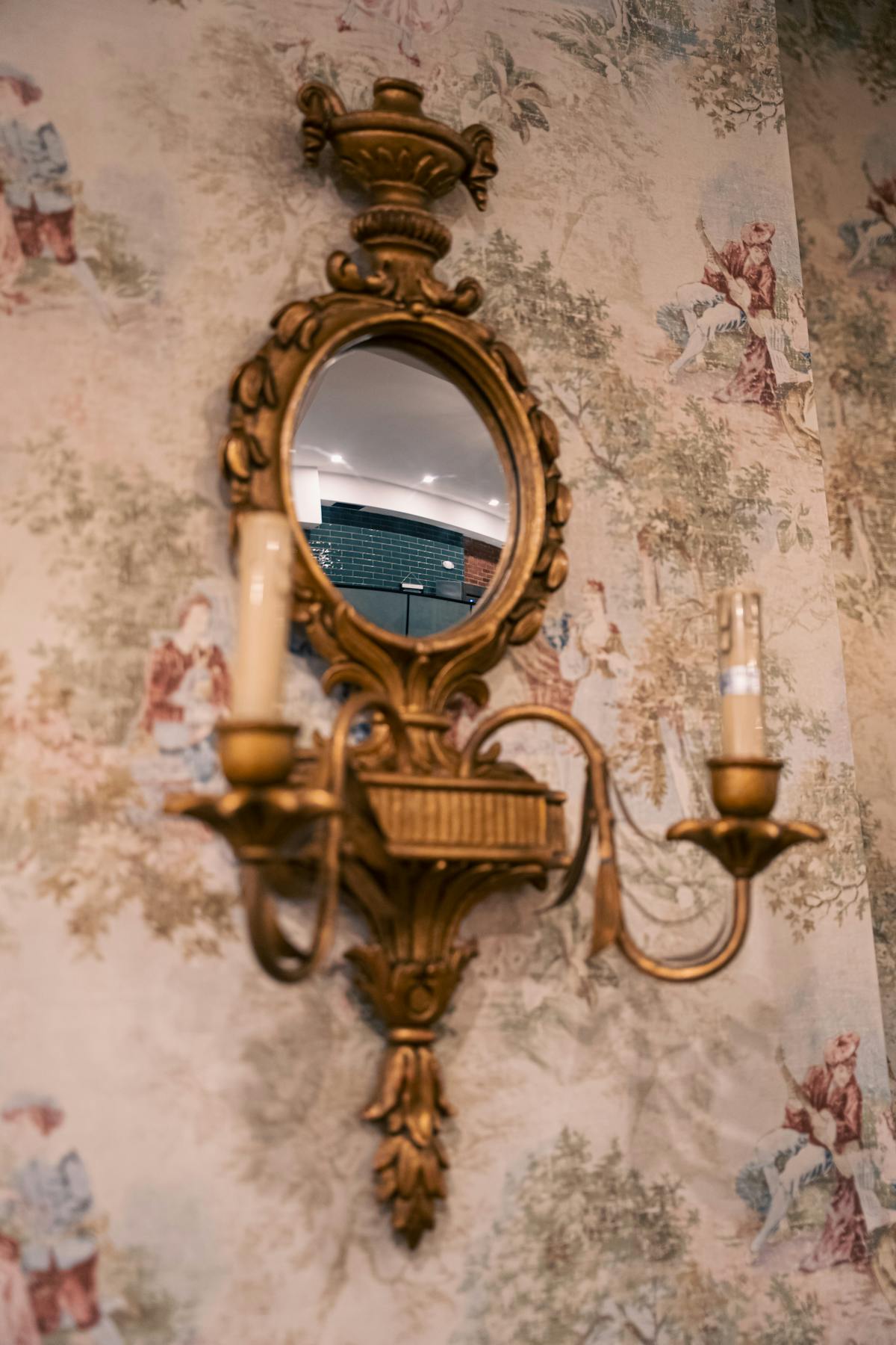 Person gazing at own reflection with contemplative posture in subdued lighting
