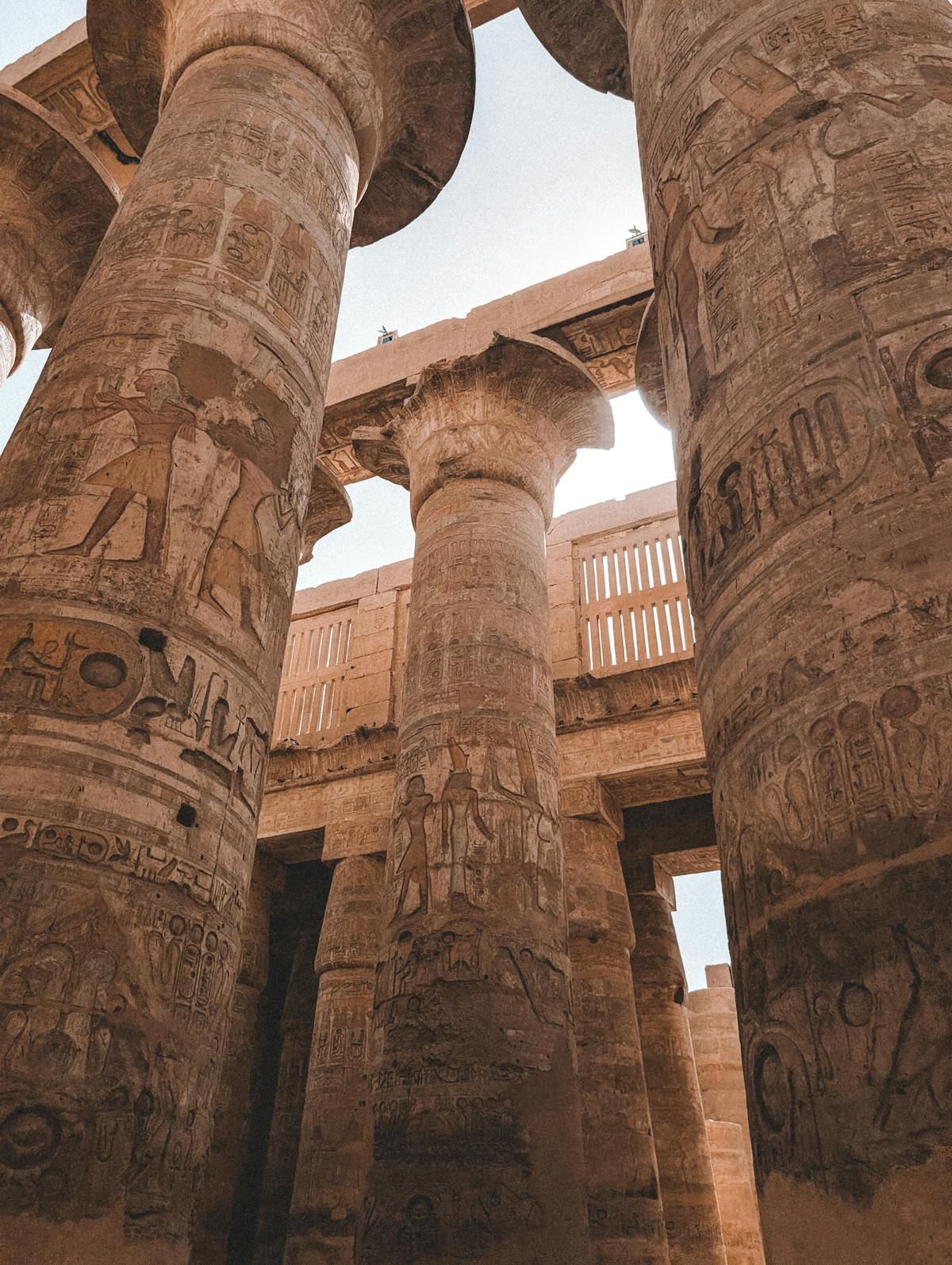 Karnak Temple colonnade representing the sacred architectural context of Egyptian mirror use and Ka theology Grand stone colonnade at Karnak Temple evoking the sacred Egyptian architecture where bronze mirrors served as ritual objects and Ka symbols