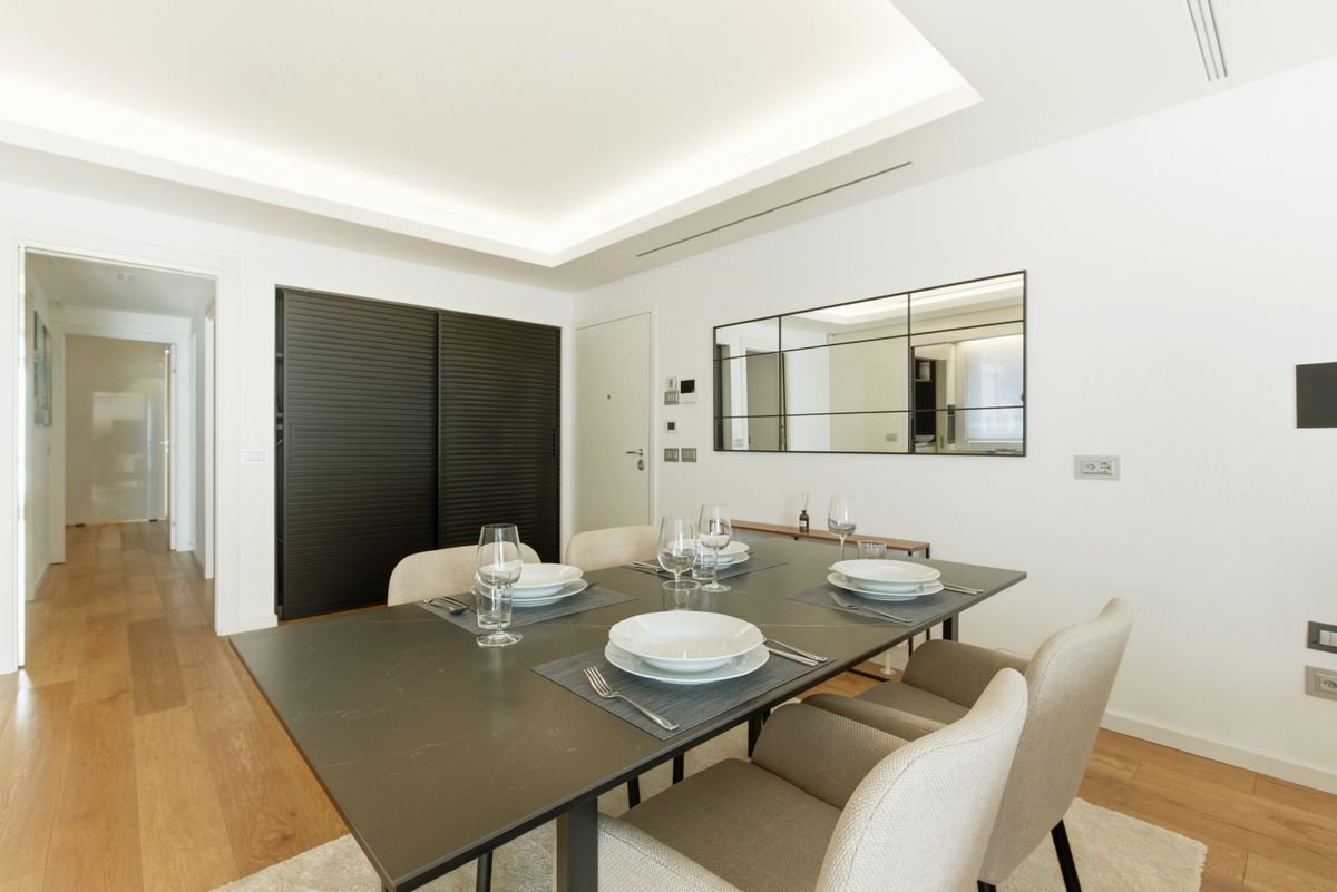 Minimalist dining room showing how to size a large dining room mirror to the table and wall