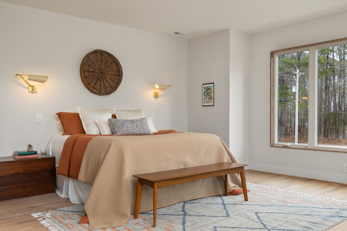 Bedroom with clear walkways illustrating feng shui clearance and pathway numbers Bedroom with wooden furniture and clear floor space by large windows, illustrating feng shui clearance and pathways