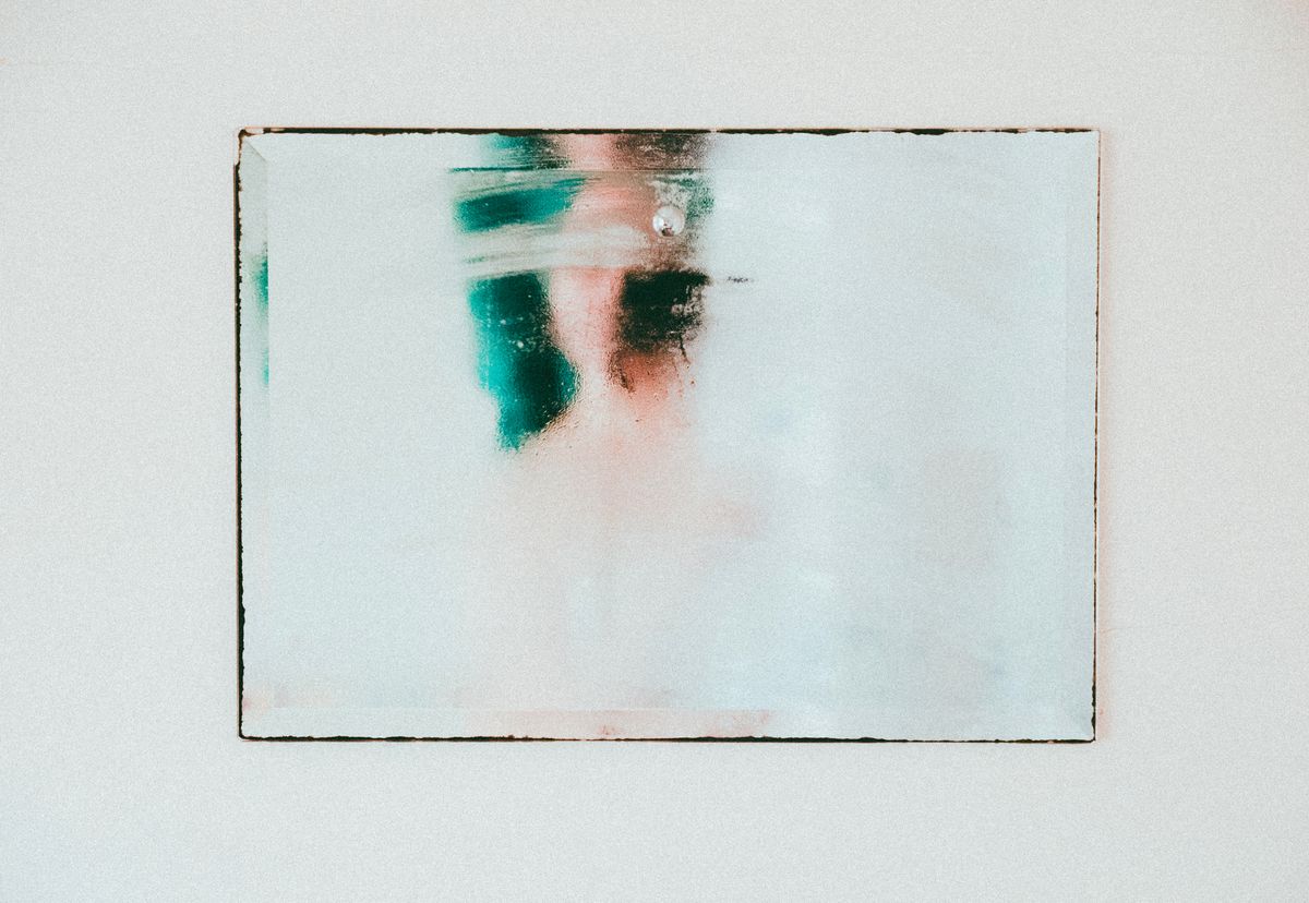 Abstract moody reflection on a fogged mirror representing an obscured or neutralized surface