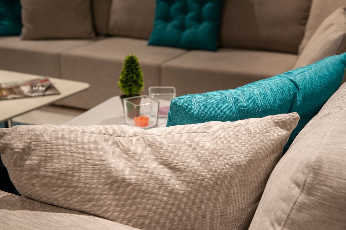Stylish living room with a neutral sofa and colorful accent pillows, illustrating the feng shui 60/30/10 color rule