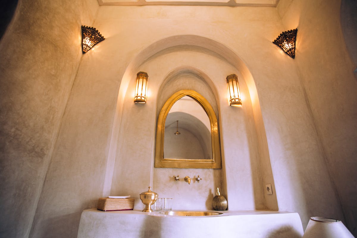 Arched mirror in a styled interior illustrating an arch full length mirror Interior featuring an arched mirror with soft lighting, illustrating arched full length mirrors