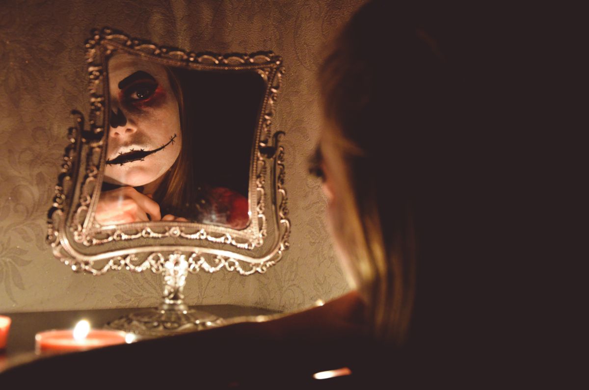 Mysterious ornate mirror with theatrical makeup evoking folklore about mirrors as gateways or uncanny portals
