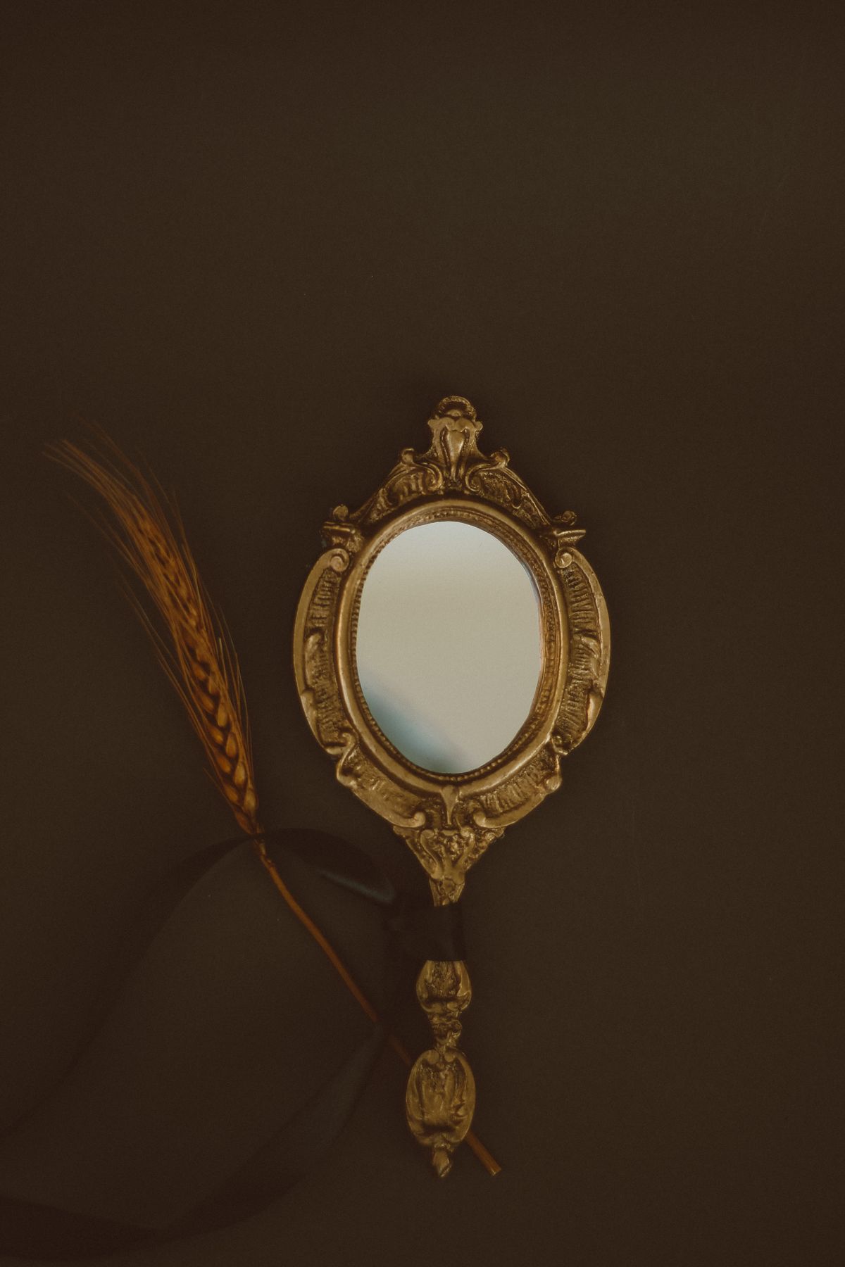 Mysterious hand reaching toward misty mirror surface with dramatic shadows