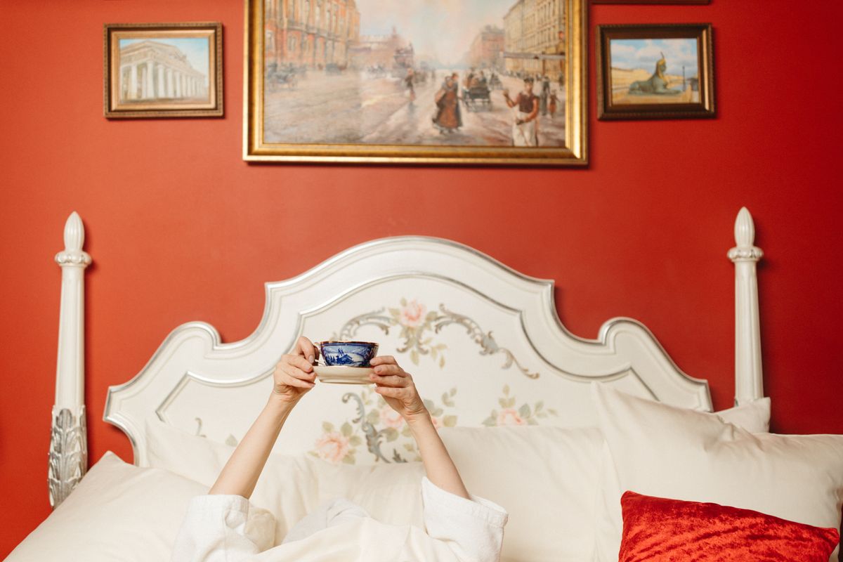 Bedroom with bold red walls and framed art, illustrating high-energy feng shui colors to use sparingly