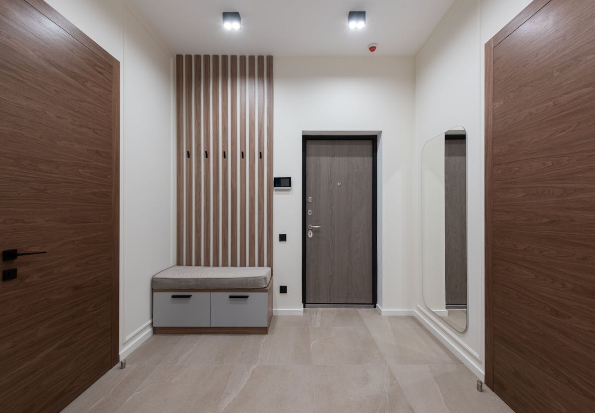 Spacious hallway with a large mirror illustrating how to size an entryway mirror Spacious modern hallway with a large mirror showing how to size an entryway wall mirror