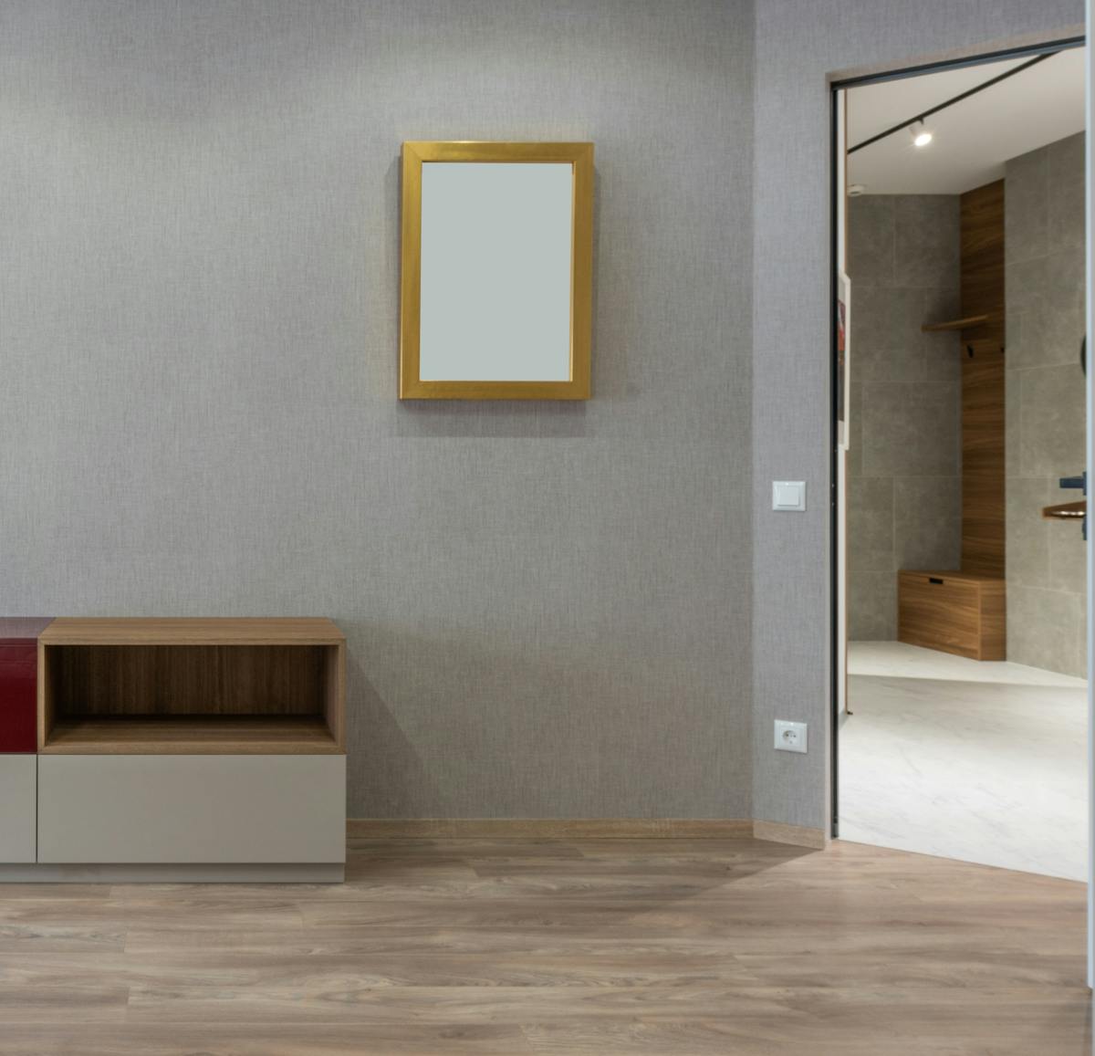 Frameless rectangular full length mirror on a gray wall illustrating frameless full length mirror style Contemporary room with a rectangular frameless full length mirror on a gray wall, illustrating frameless full length mirrors