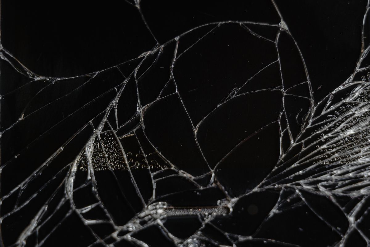 Shattered glass macro texture illustrating broken mirror dream meaning and identity fracture Close-up of shattered glass fragments showing delicate fracture patterns tied to broken mirror dream symbolism