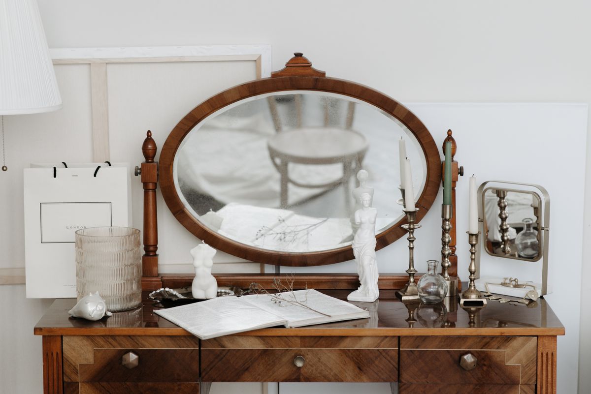Antique dressing table with an ornate mirror illustrating a vintage dresser with mirror style Antique dressing table with an ornate mirror and candles showing a vintage dresser mirror style