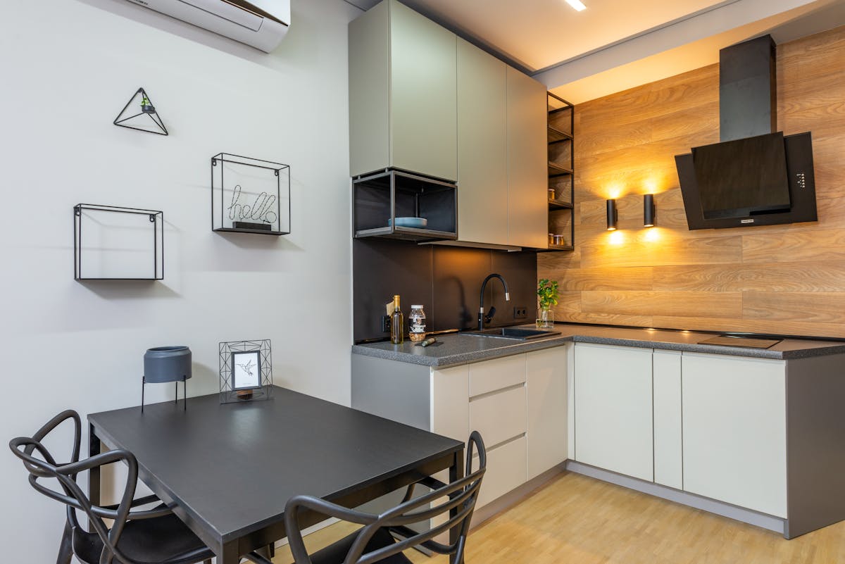 Modern kitchen with a decorated wall and appliances, illustrating why metal wall art suits a kitchen