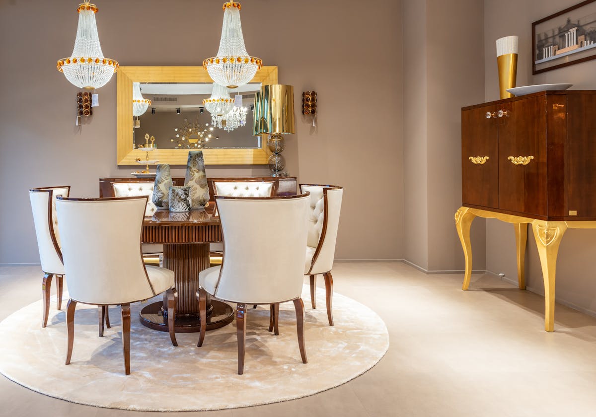 Console styling with a wall mirror illustrating round mirror decor in an entryway Round wooden table with vases near a wall mirror in a bright apartment, illustrating round mirror decor in an entryway