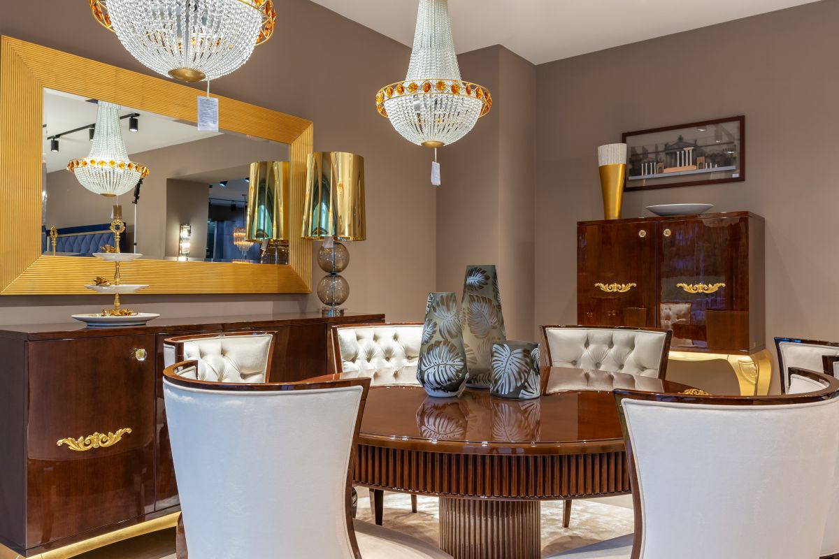 Mirror reflecting a dining table, illustrating the feng shui wealth-cure tradition for dining room mirrors Round dining table reflected in a nearby mirror, illustrating the feng shui dining room mirror tradition
