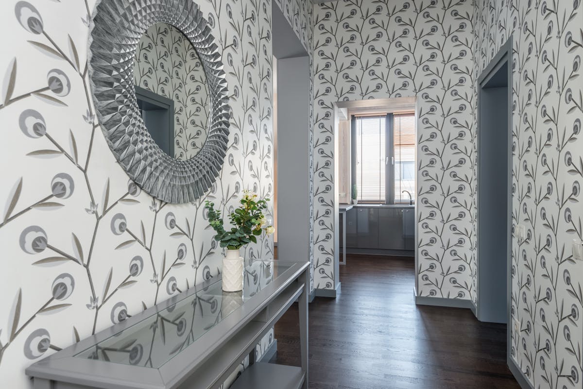 Contemporary hallway mirror reflecting light, showing what an entryway mirror should reflect Contemporary hallway with a mirror above a table reflecting light, showing what an entryway mirror should reflect