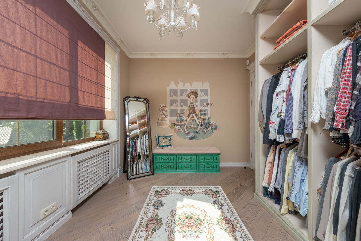Walk-in wardrobe with a full-length mirror illustrating full-length wardrobe mirror layout Walk-in wardrobe with a full-length mirror and chandelier showing full-length wardrobe mirror placement