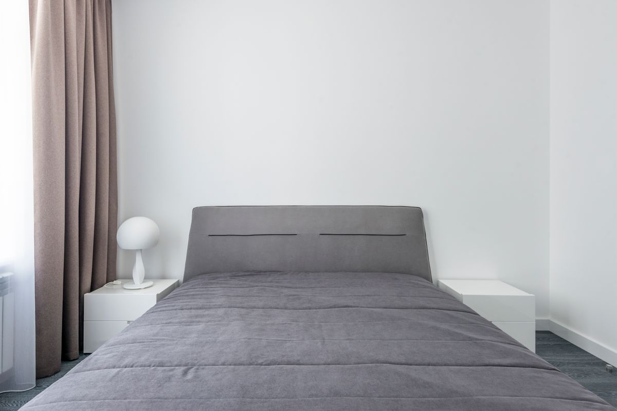 Bedroom arranged in the feng shui commanding position with a clear view of the door Serene minimalist bedroom with the bed placed to view the room, illustrating the feng shui commanding position