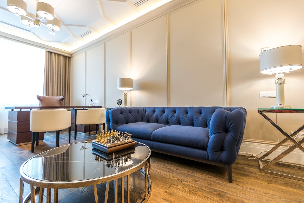 Bright modern living room with a blue couch and natural light, illustrating the calming feng shui Water element