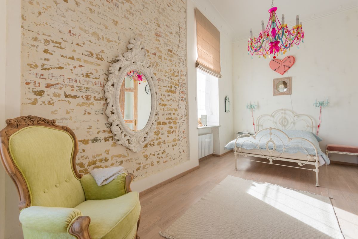 Glamorous mirror and chandelier illustrating beveled and Art-Deco mirror wall panels Glamorous room with an ornate mirror and chandelier, illustrating beveled and Art-Deco mirror wall panels