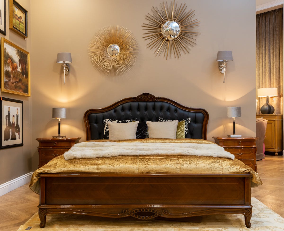 Framed mirror mounted above a bed headboard showing safe mirror above bed placement Elegant bedroom with a framed mirror above the headboard illustrating how to hang a mirror above the bed safely