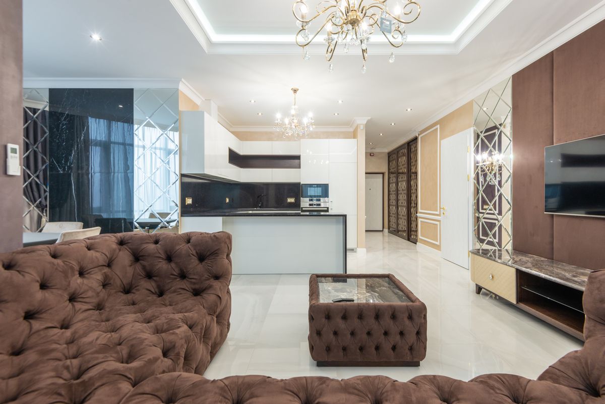 Plush living room illustrating how to keep a mirrored accent wall elegant rather than stark Plush modern living room with elegant lighting, illustrating how to style a mirror accent wall elegantly