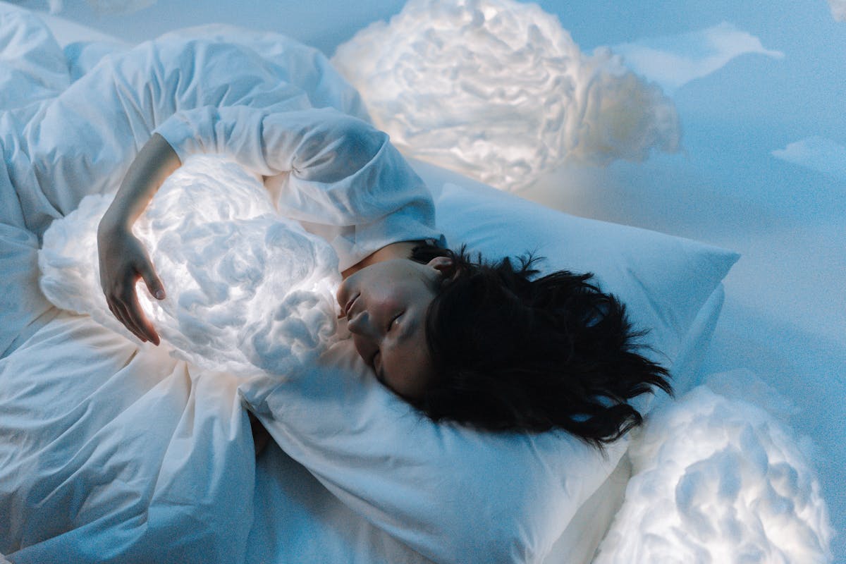A woman in a serene dreamlike setting representing the subconscious meaning of dreaming of a cardinal