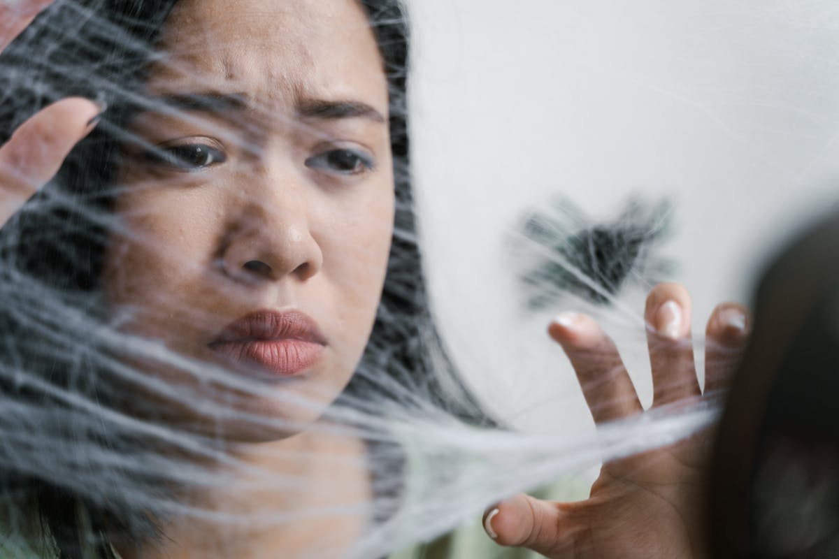 Close-up of a woman showing fear and anxiety representing the layered causes behind the fear of mirrors