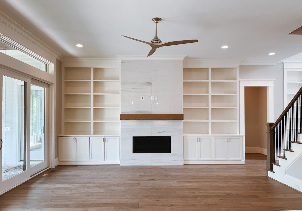 Living room with a fireplace and built-in shelving as a feature wall, illustrating a fireplace accent wall